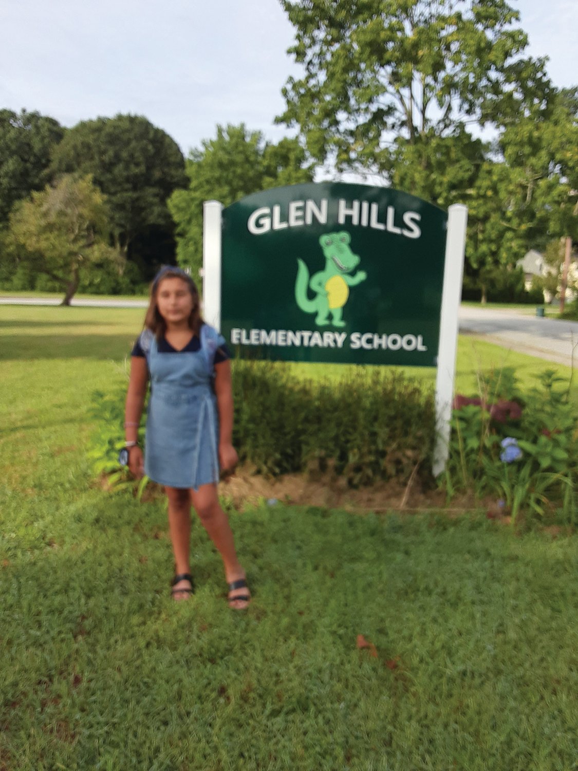 A NEW FIFTH-GRADER:  Guiliana Carley, an incoming fifth-grade student at Glen Hills Elementary School this year, posed for photos with her family as she waited for the school day to begin.